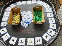 two wooden boxes are sitting on top of a game board with numbers and dices