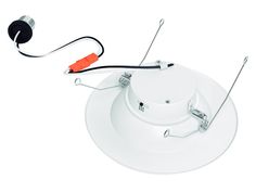 a white ceiling light with two wires connected to it and an orange cord attached to the base