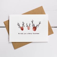 two reindeer heads with antlers on them and the words, wish you a merry christmas