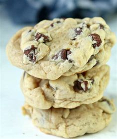 three chocolate chip cookies stacked on top of each other