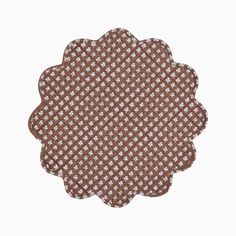 a brown and white checkered doily on a white background