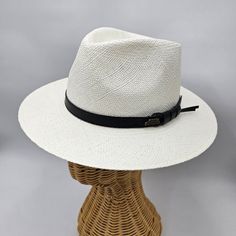 Panama Hat Indiana Style with leather strap, meticulously crafted to evoke timeless sophistication. Each strand woven with precision, it exudes vintage charm and unparalleled elegance, offering a stylish nod to a bygone era. This Panama hat was hand woven by skilled natives in Ecuador and it was carefully completed in Italy. Made from the fibers of the Toquilla Palm plant native to Ecuador. The hat gained international fame during the construction of the Panama Canal in the late 19th and early 2 White Adjustable Panama Hat For Formal Occasions, White Brimmed Panama Hat For Formal Occasions, White Flat Brim Fedora For Formal Occasions, White Formal Panama Hat, Elegant Adjustable Braided Hat, White Formal Panama Hat With Short Brim, Classic White Hat Bands For Formal Events, White Panama Hat With Curved Brim For Formal Occasions, White Curved Brim Panama Hat For Formal Occasions