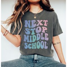 Celebrate your graduate's journey from elementary school to the exciting adventure of middle school with our special graduation shirt. Featuring the bold and empowering message 'Next Stop Middle School,' this shirt is a perfect way to commemorate this important transition in their academic journey. 🎓 Meaningful Design: Our shirt captures the spirit of graduation with its empowering message, symbolizing the exciting next chapter awaiting your graduate as they move on to middle school. 👕 Comfort Back To School Spirit Shirt With Text Print, Back To School T-shirt With School Spirit Style, School Spirit T-shirt For Back To School, School Spirit T-shirt Relaxed Fit For Back To School, Casual Letter Print T-shirt For School Events, School Spirit T-shirt With Lettering For College, College Spirit T-shirt With Lettering, Graphic Tee For End Of School Year Events, End Of School Year Graphic Tee For School Events