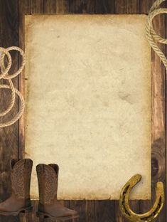 an old paper, cowboy boots and rope on a wooden background with copy - space for text