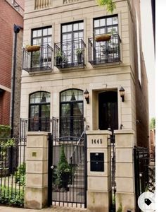 an apartment building with wrought iron gate and windows