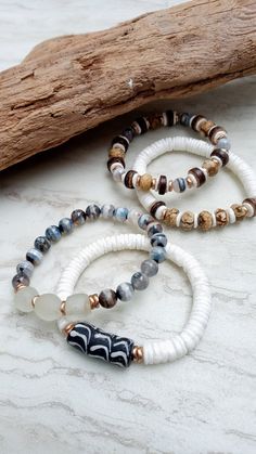 Soft, serene, cozy, and beachy. Beautiful beige, gray, white, and ecru in these mixed medium stack bracelets. Black and white handmade recycled glass, crisp white shell disks, faceted Picture Jasper rondelles, stunning Tibetan Agate in gradient gray, coconut disks, African recycled glass, and mixed metals. Unique and stunning. The item/s pictured is the item you will receive. Bracelets is 7.0" to 7.5" in length. HavSolStudio on ETSY | Mixed media . Earthy elegance . Great texture . Beach inspire White Stacked Beaded Bracelets For The Beach, White Bohemian Stackable Bracelets, Bohemian White Stackable Bracelets, White Stacked Beaded Bracelets, White Bohemian Stretch Bracelet Hand Wrapped, Bohemian White Stretch Bracelet Hand Wrapped, White Stacked Bohemian Beaded Bracelets, White Bohemian Stacked Bracelets, Bohemian White Stacked Bracelets