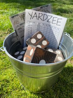 a bucket full of yardzee dices sitting in the grass