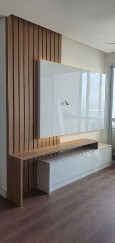 an empty room with wood paneling and white furniture on the wall next to a sliding glass door