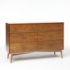 a wooden dresser sitting on top of a white floor