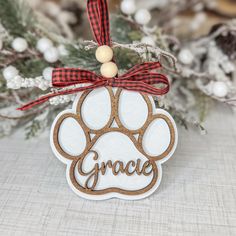 a wooden ornament with a dog's paw and the word grace on it