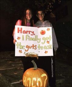 two people holding a sign that says harry, i finally got the guts to ask