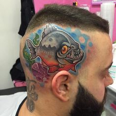 a man with a fish tattoo on his head