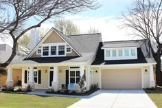 a house with white trim and black roof