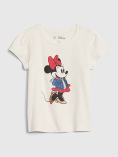 Soft knit.  Short flutter sleeves.  Crewneck.  Minnie Mouse graphic at front.  #626686 Straight easy fit.  Hits at the hip. Minnie Mouse Disneyland, Lego Shirts, Mickey Mouse And Minnie Mouse, Baby Minnie, Baby Minnie Mouse, American Brand, Knit Short, Gap Kids, Disney Shirts