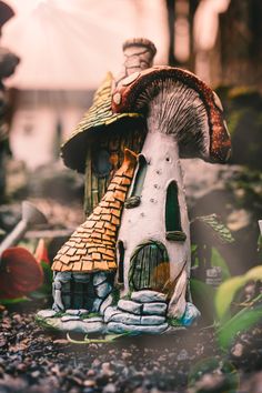 a close up of a mushroom house on the ground