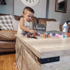 a little boy playing with blocks on the table