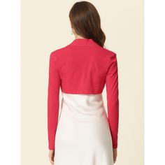 This versatile shrug is a must-have for any fashion-forward wardrobe. Its soft and lightweight knit material makes it comfortable to wear, while the long sleeves and crop length offer a chic and modern look. The clean, collarless silhouette is precisely cropped above the waist, making it the perfect cover-up for any occasion or event. You can easily pair it with a white dress or sleeveless dress to showcase your graceful gesture. With its contemporary design and effortless style, this shrug is s Fitted Solid Color Open Front Cardigan, Fitted Open Front Solid Color Cardigan, Elegant Long Sleeve Crop Top For Winter, Elegant Long Sleeve Winter Crop Top, Fitted Shrug For Spring Layering, Spring Fitted Shrug For Layering, Chic Cropped Shrug For Spring, Chic Cropped Spring Shrug, Long Sleeve Stretch Shrug For Spring