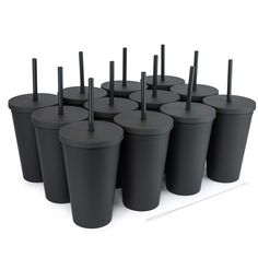 the cups are lined up in rows and have black straws sticking out of them