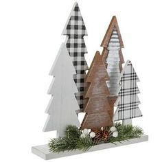 three wooden christmas trees on display with pine cones and plaid ribbon around the tree tops