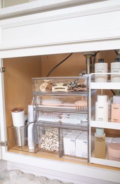 the inside of a bathroom cabinet filled with beauty products