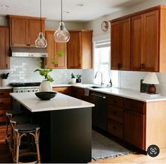 a kitchen with wooden cabinets and white counter tops