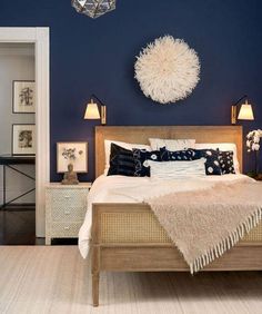 a bedroom with blue walls and white furniture