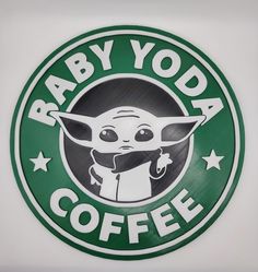 a baby yoda coffee sign on the side of a building