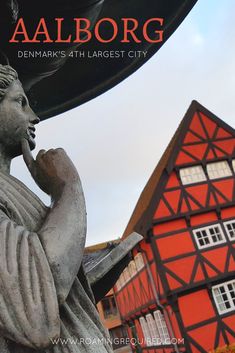 an image of a statue in front of a building with the words aalborg on it