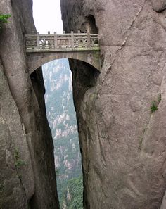 the bridge is built between two large rocks