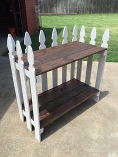 a wooden table with white pickets on it