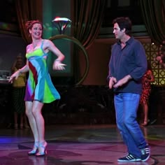 a man and woman are dancing on stage