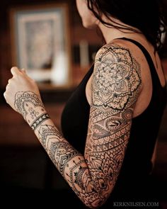 a woman with tattoos on her arm and arms