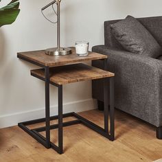 a living room with a couch, table and lamp on the floor next to it