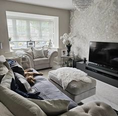 a living room filled with furniture and a flat screen tv