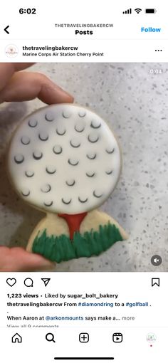 someone is holding a fake golf ball cookie