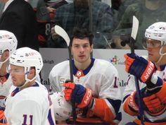 the hockey players are waiting for their turn to play