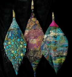 three pieces of art made out of fabric and wire on a black background, each with different colors