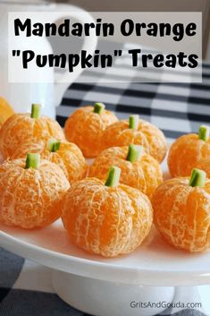 mandarin oranges on a white plate with the words mandarin orange pumpkin treats above them