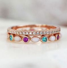 three different colored stones are on top of each other in this wedding band ring set