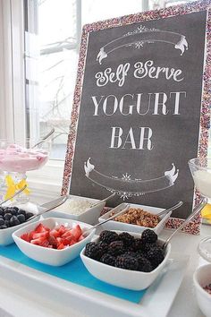 there is a sign that says self serve yogurt bar and bowls of fruit