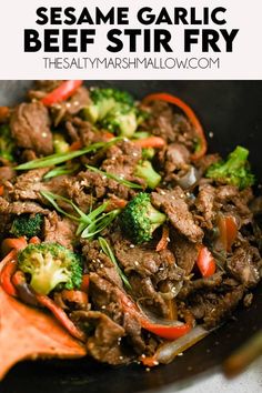 beef and broccoli stir fry in a skillet with text overlay that reads sesame garlic beef fry