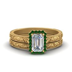 an emerald colored engagement ring set with filigrees on the sides and side