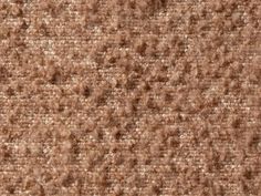 a brown carpet with small holes in it