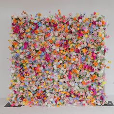 an art piece made out of flowers on display