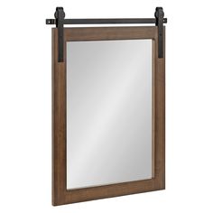 a mirror that is hanging on the wall with some black metal bars in front of it