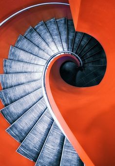 a spiral staircase in an orange building