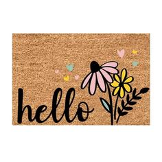 a door mat with the word hello written on it and flowers in front of it