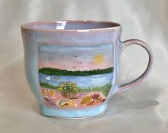 a coffee cup with a painting on the inside of it's rim and bottom