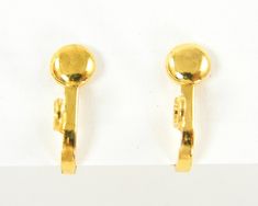 two pairs of gold colored earrings on white background