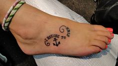 a small tattoo on the foot of a person with an anchor and i refuse to miss